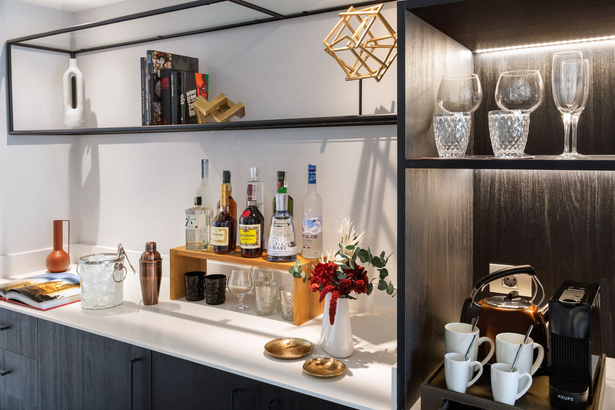 a shelf with liquor bottles and glasses on it