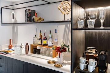 a shelf with liquor bottles and glasses on it