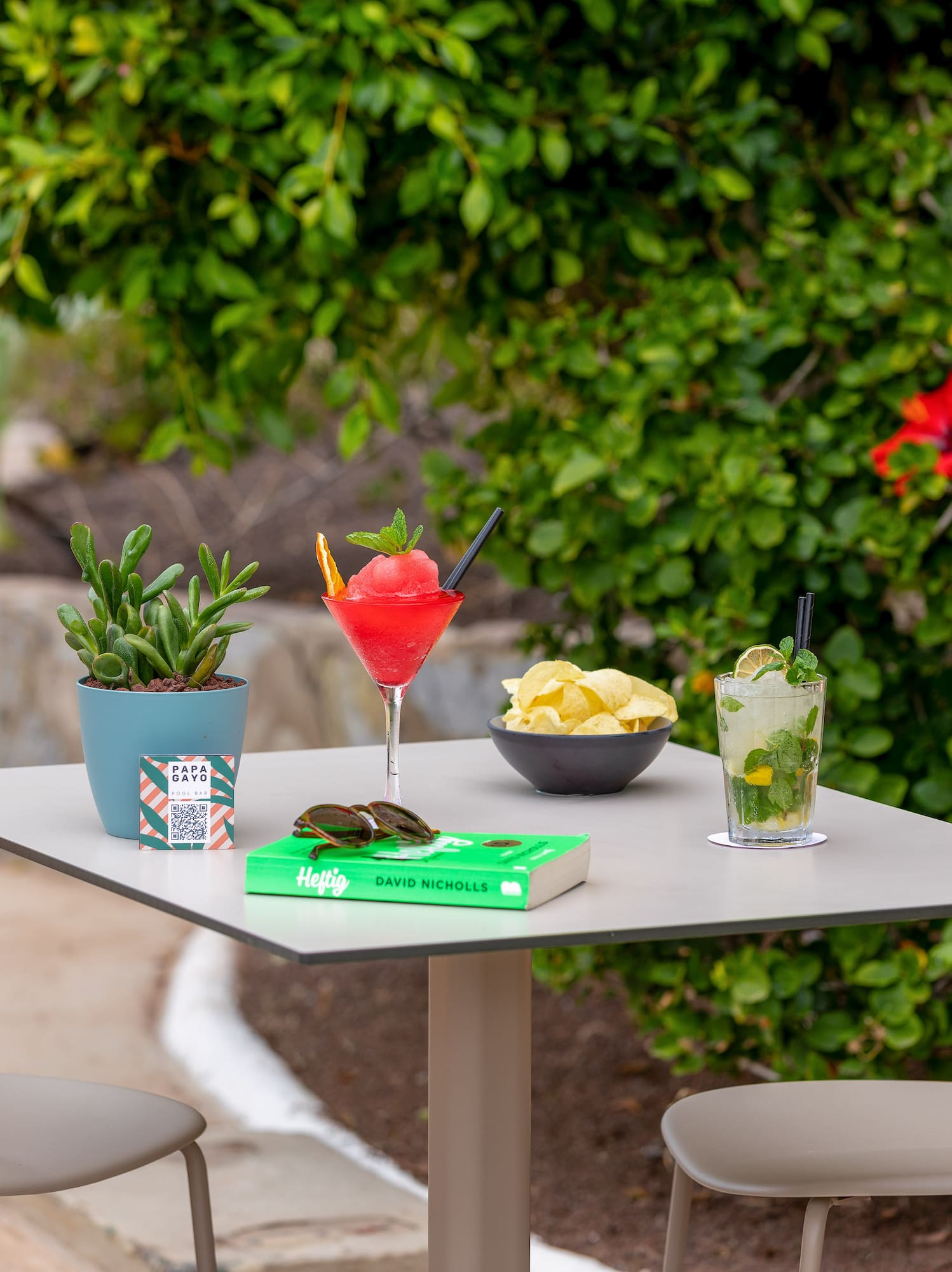 a table with drinks and a book on it