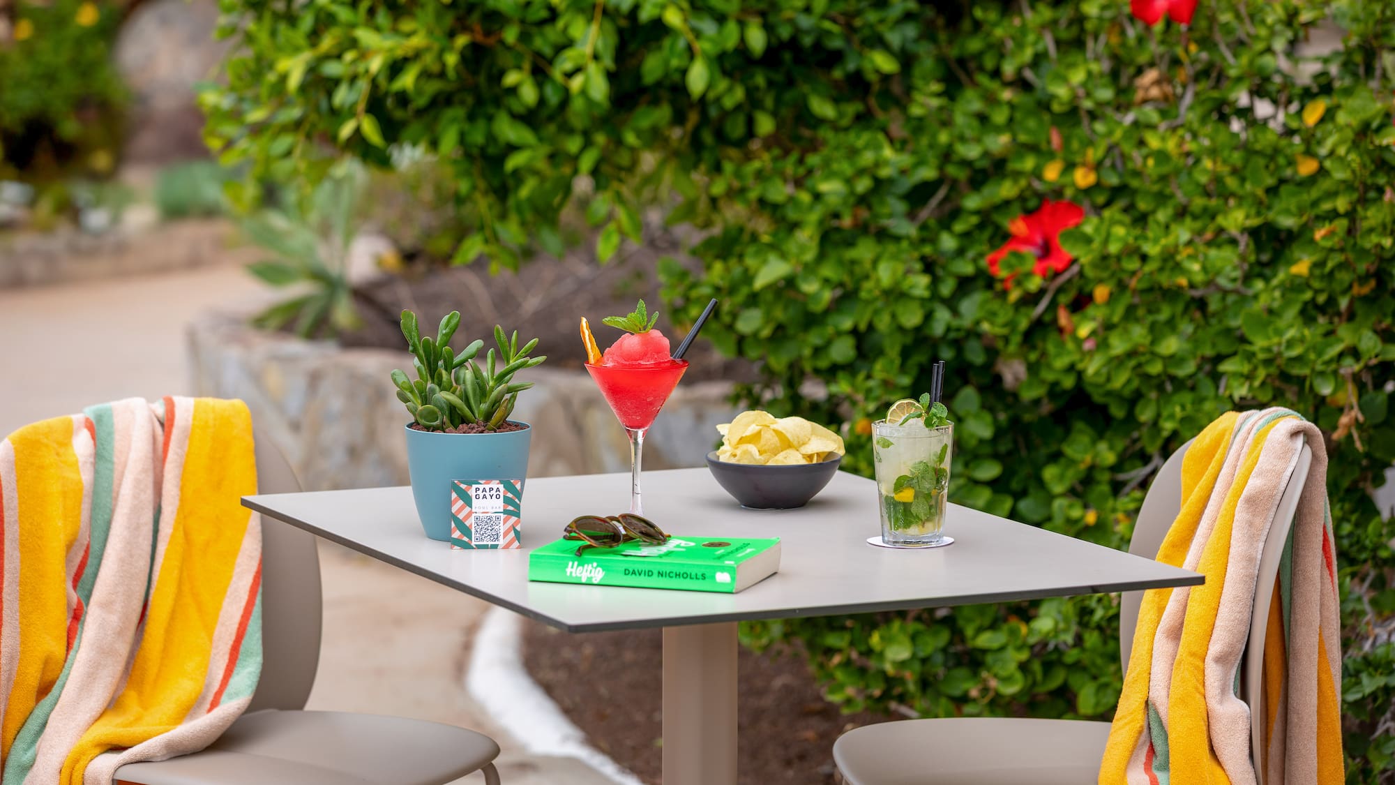 a table with drinks and a book on it