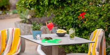a table with drinks and a book on it