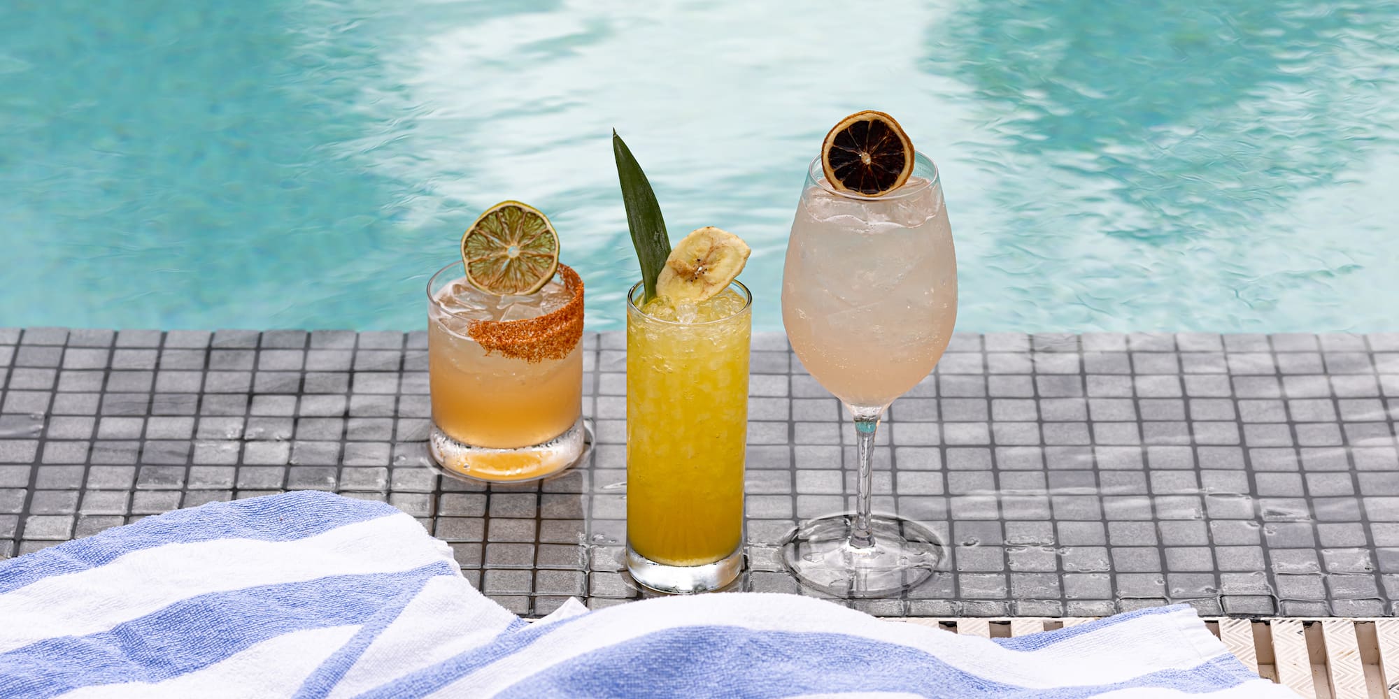 a group of drinks on a pool side