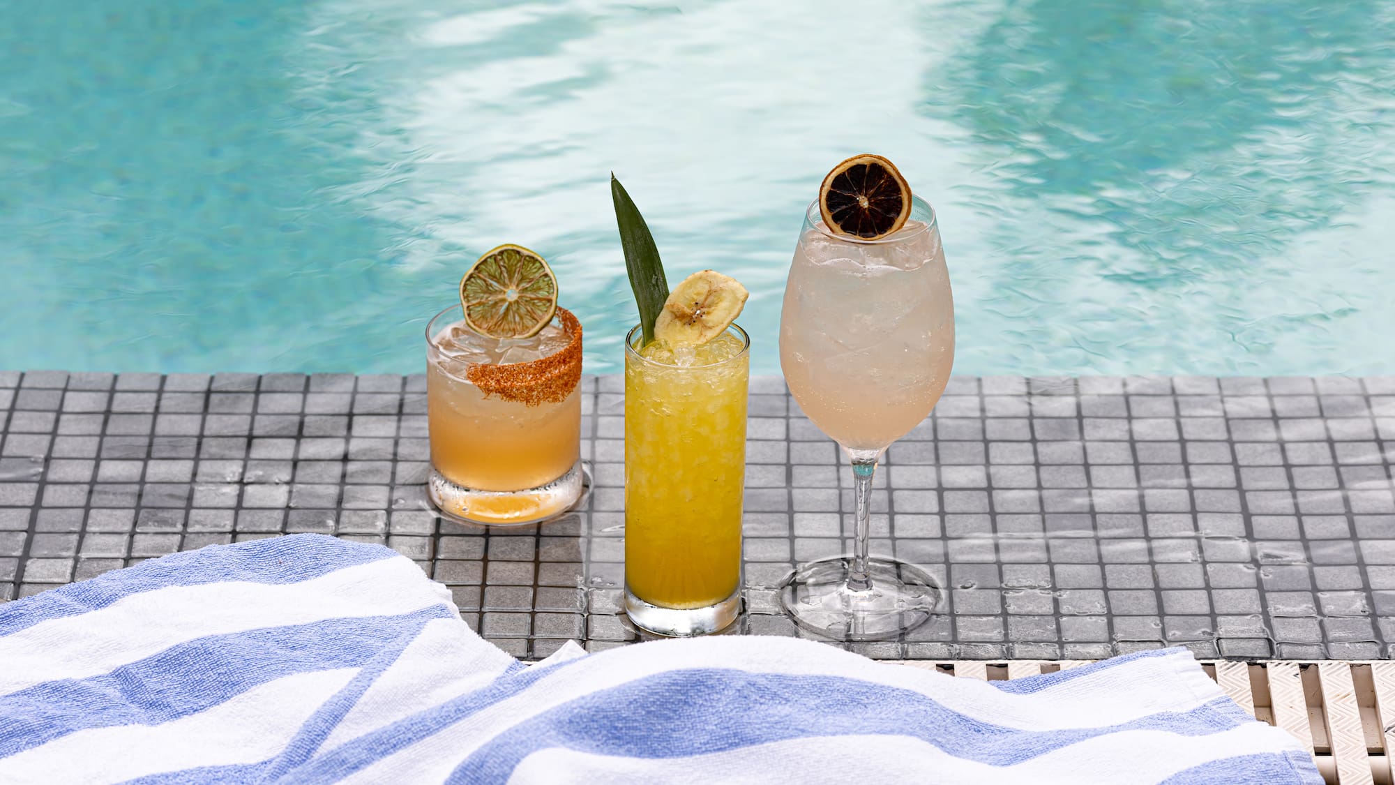a group of drinks on a pool side