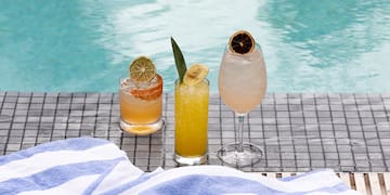 a group of drinks on a pool side