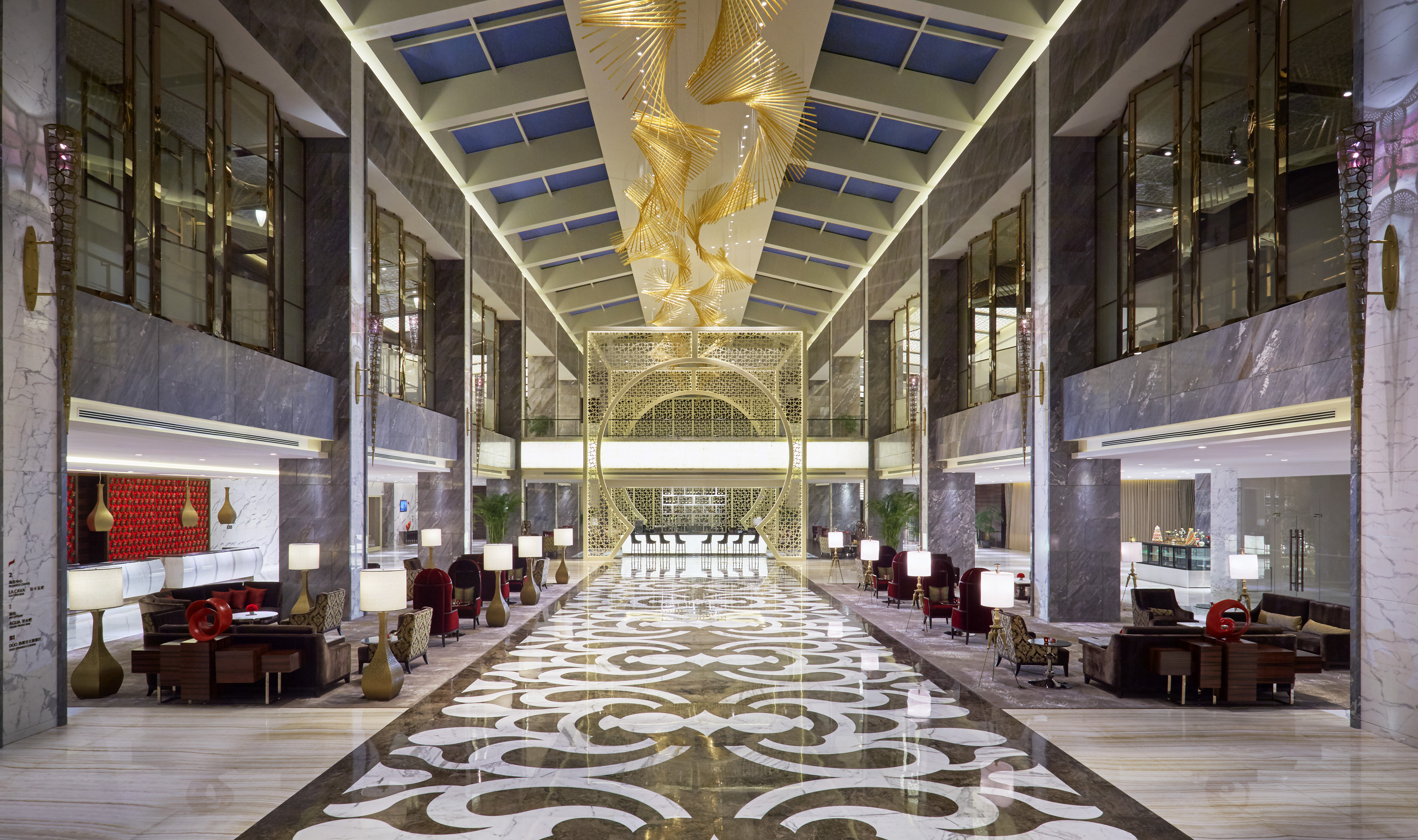 Grand hotel lobby: gold chandelier, patterned marble floor, elegant seating.