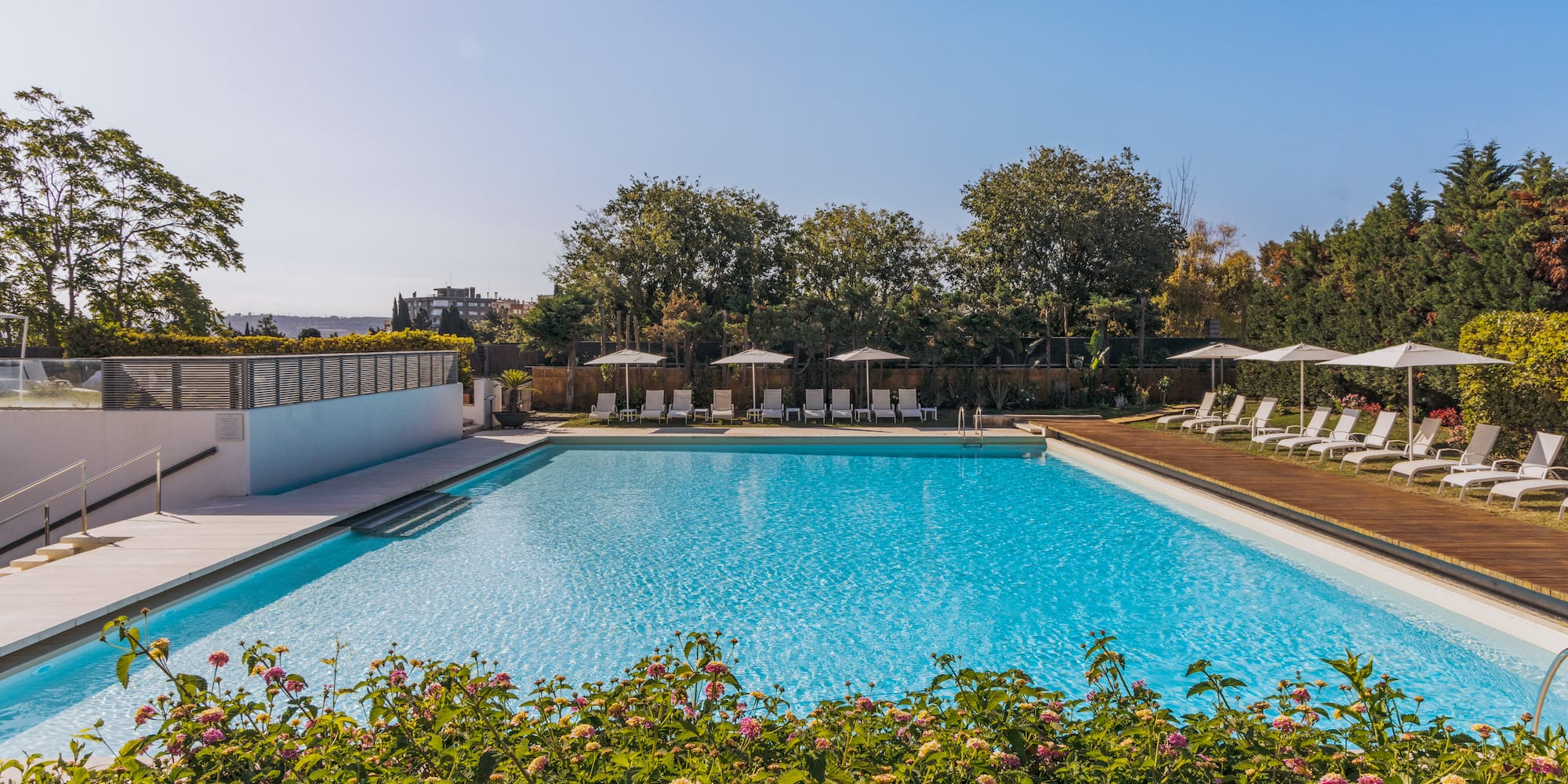a pool with chairs and umbrellas