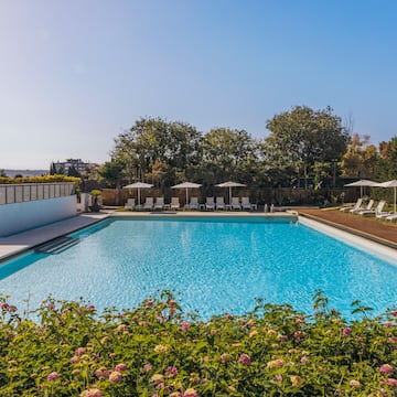 a pool with chairs and umbrellas