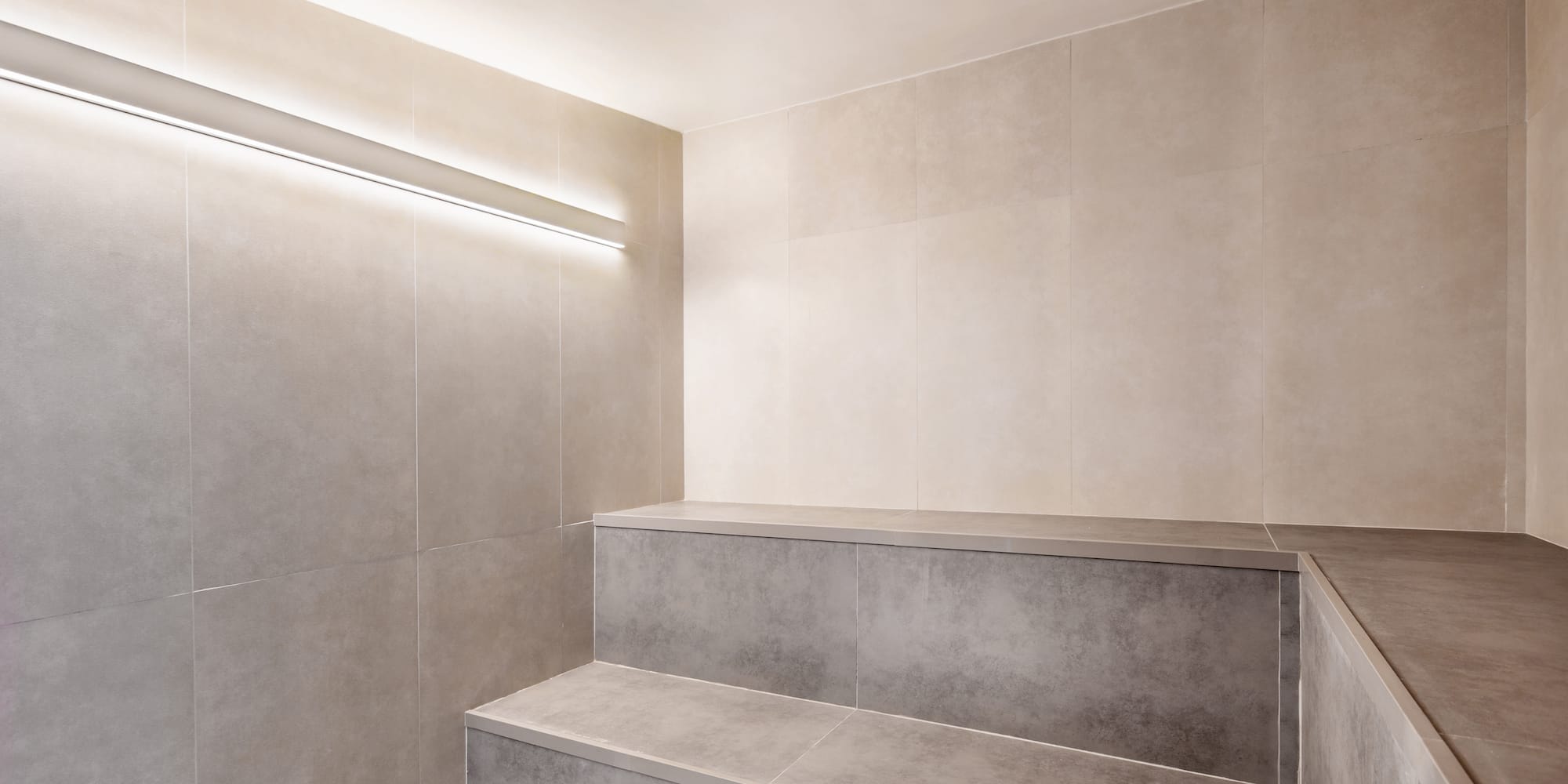 a room with a bench and a light