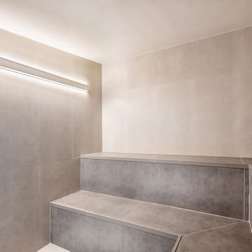 a room with a bench and a light