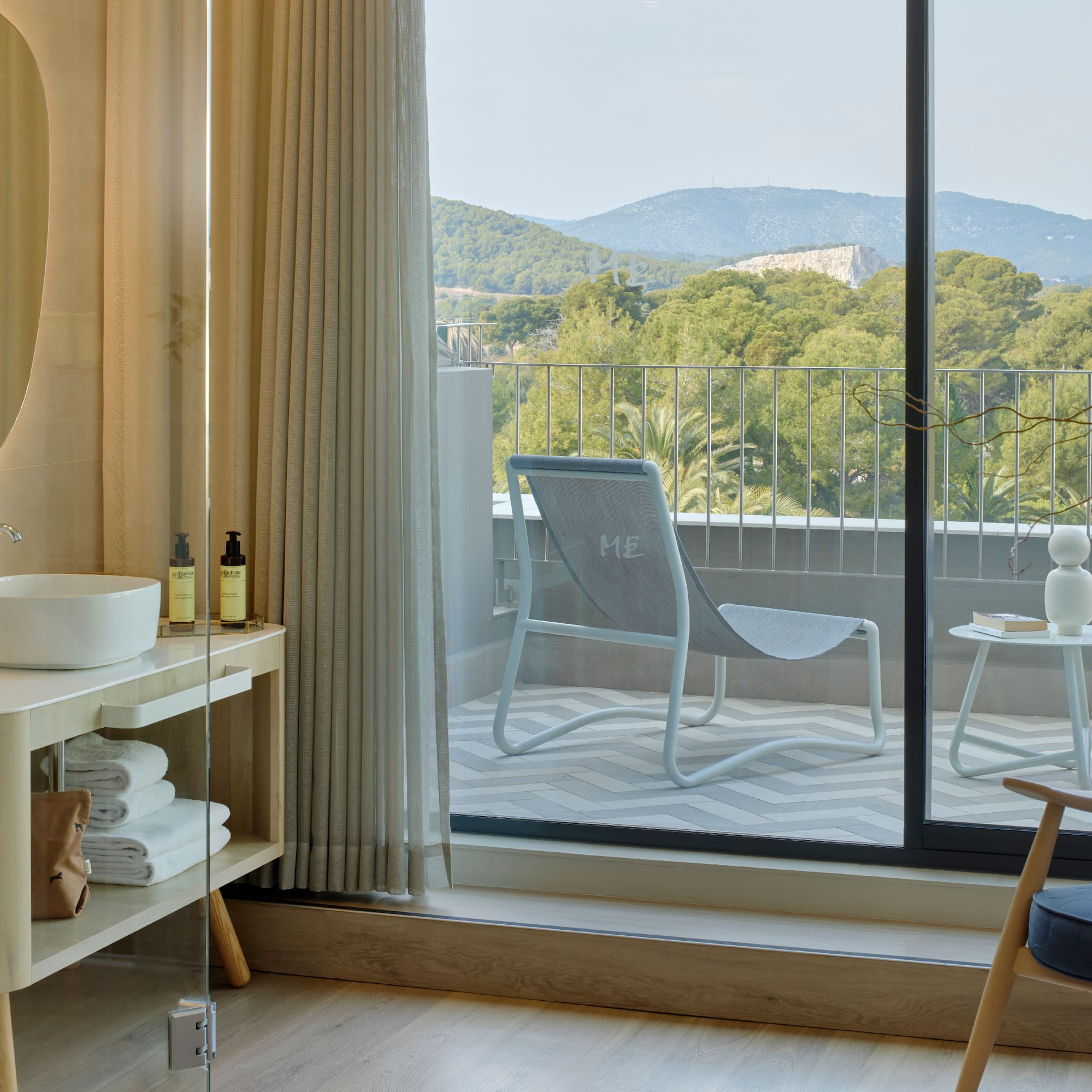 a room with a glass door and a chair and a table