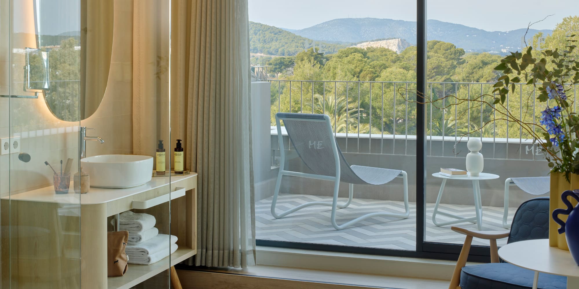 a room with a glass door and a chair and a table