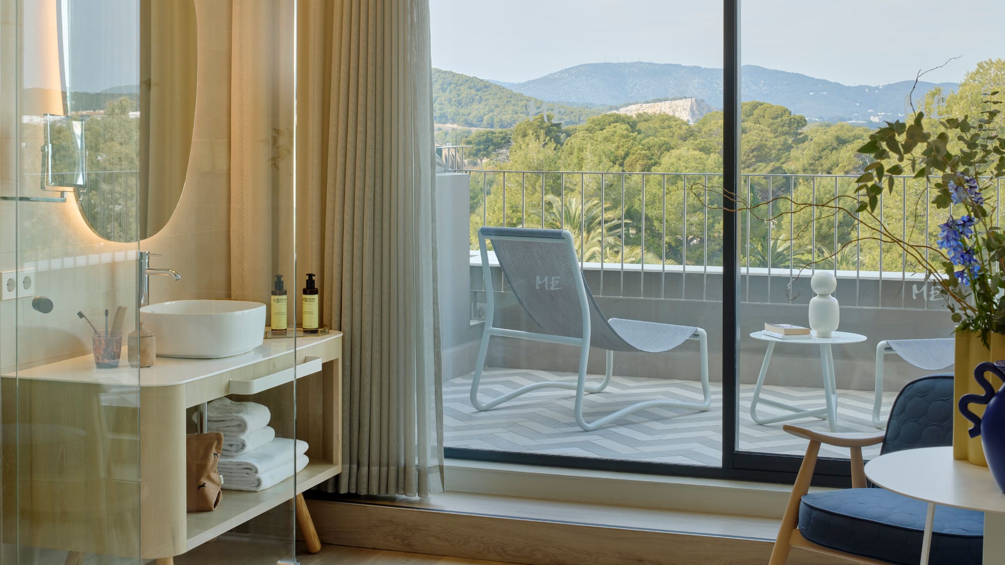 a room with a glass door and a chair and a table