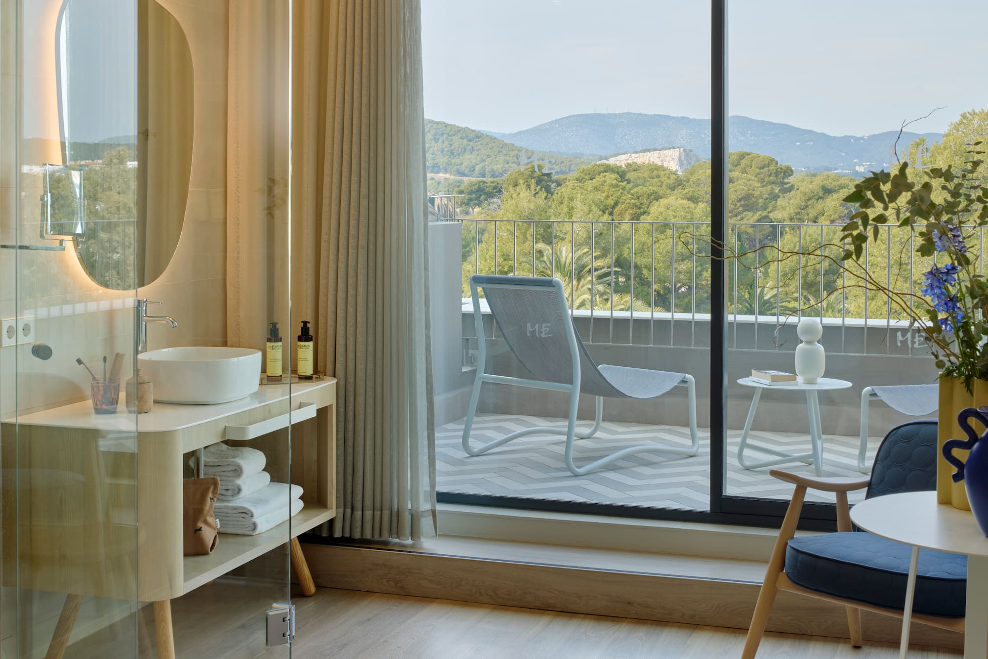 a room with a glass door and a chair and a table