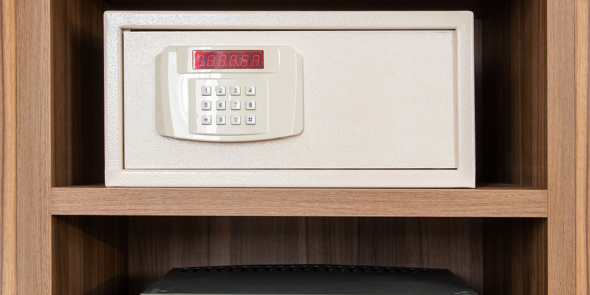 a safe with a digital display and a small refrigerator