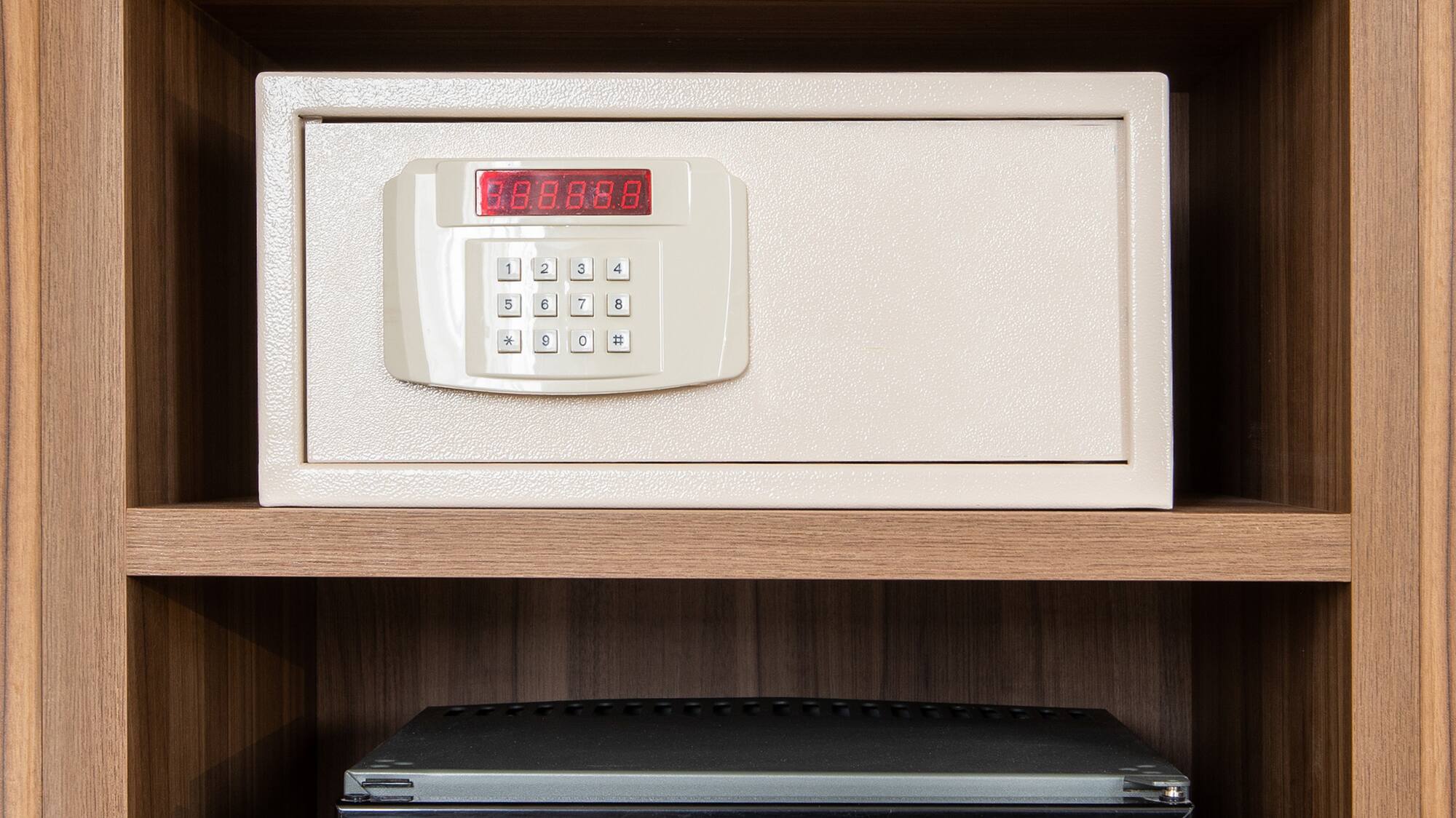 a safe with a digital display and a small refrigerator