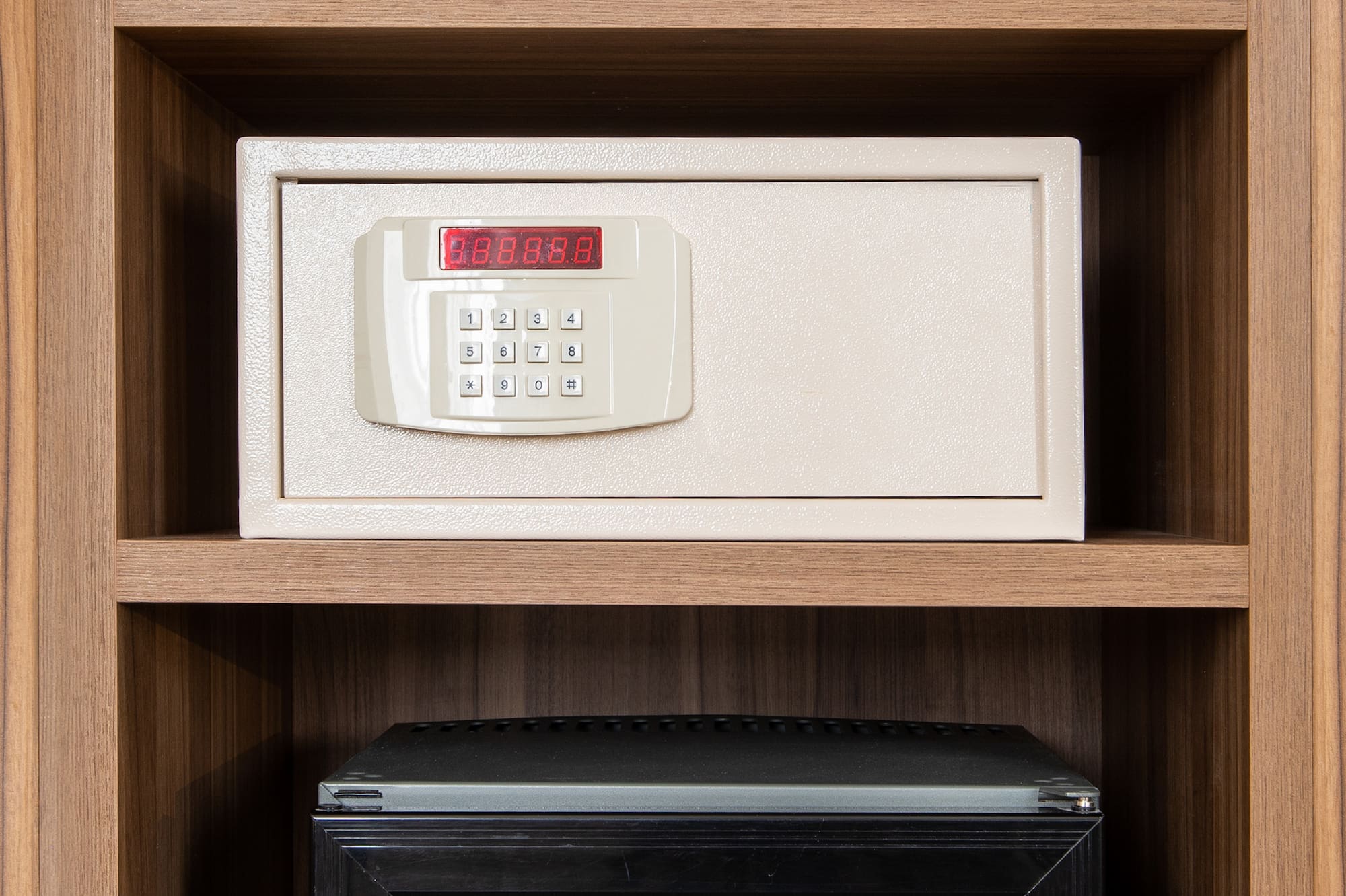 a safe with a digital display and a small refrigerator
