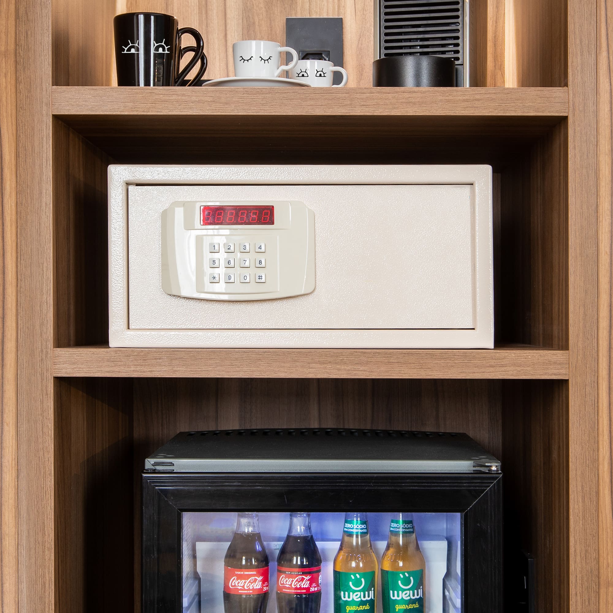 a safe with a digital display and a small refrigerator