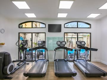 a room with treadmills and a tv