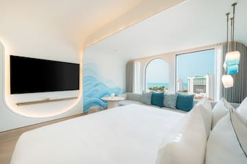 a room with a bed and a television