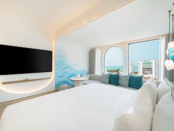 a room with a bed and a television