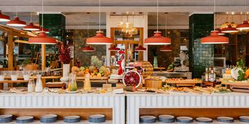 a food buffet with plates and fruits