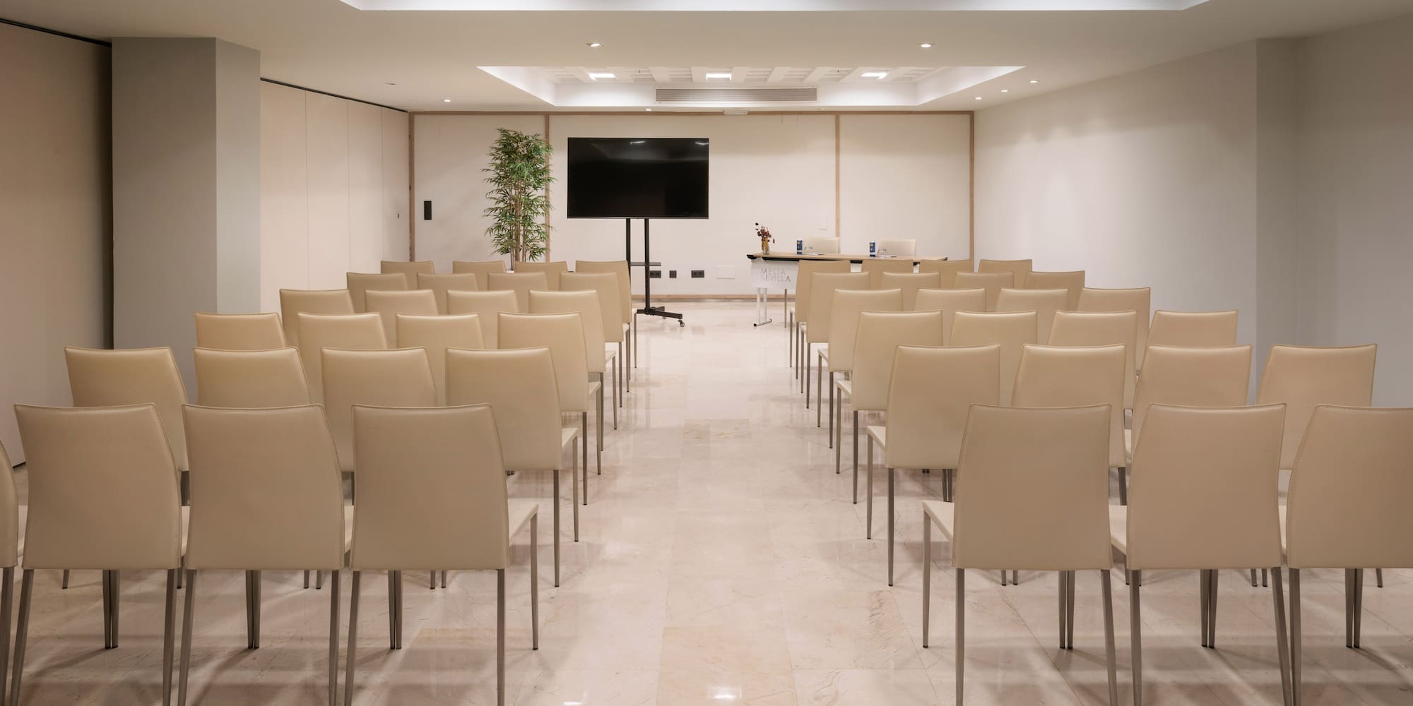 a room with chairs and a screen