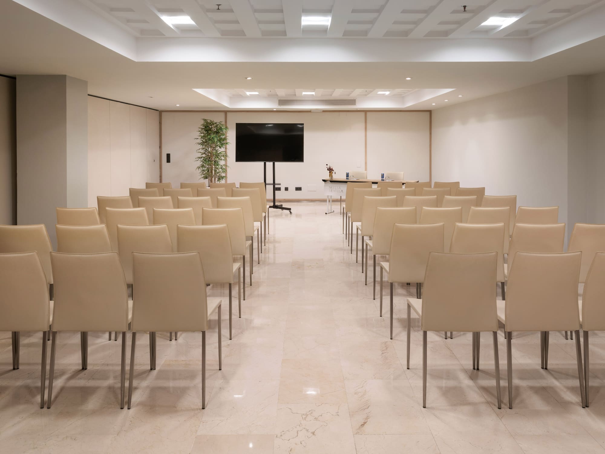 a room with chairs and a screen