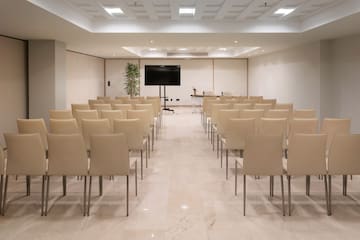 a room with chairs and a screen