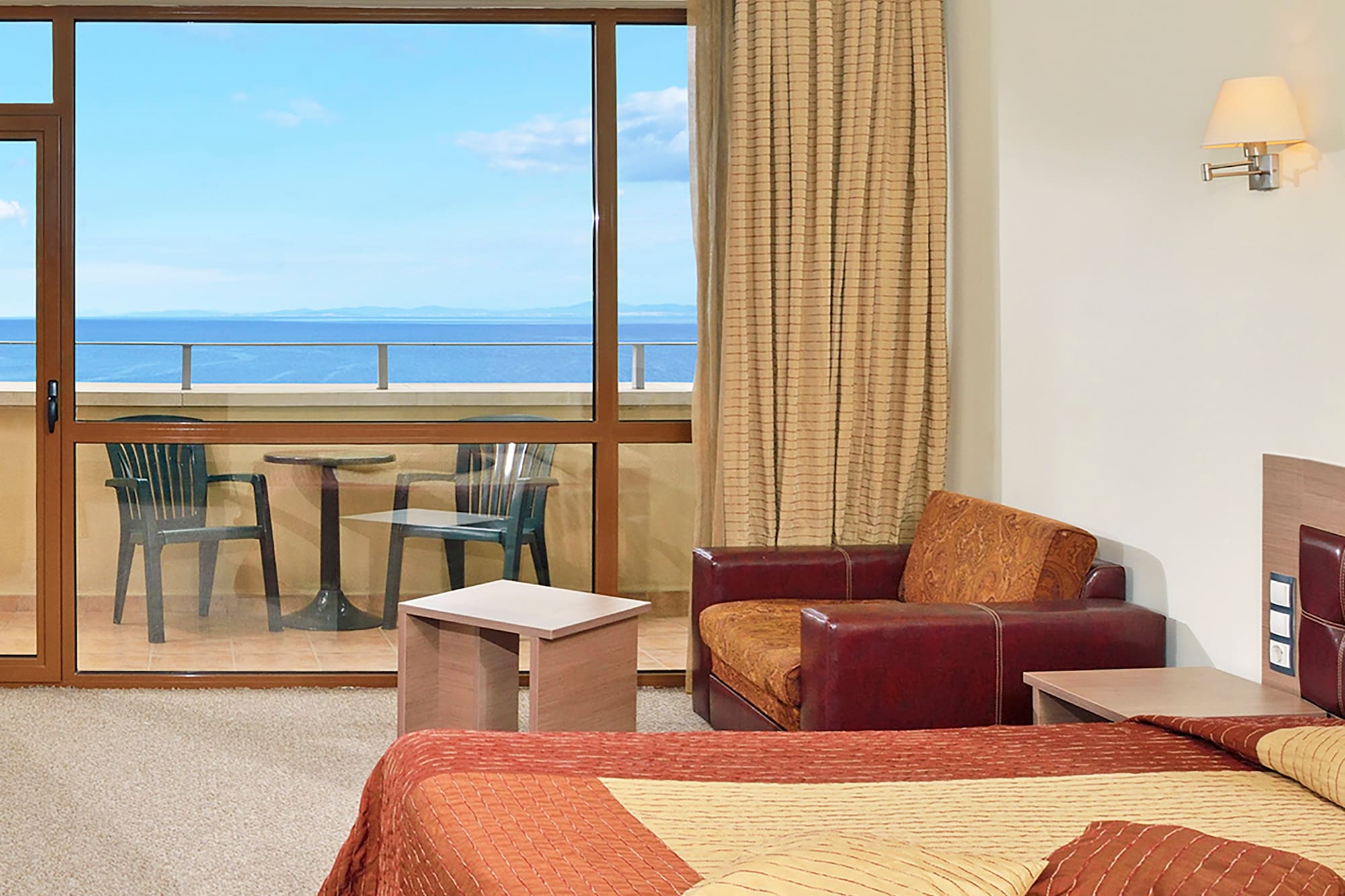 a room with a bed and a glass door