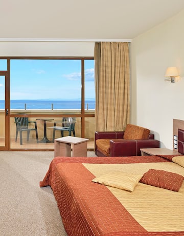 a room with a bed and a glass door