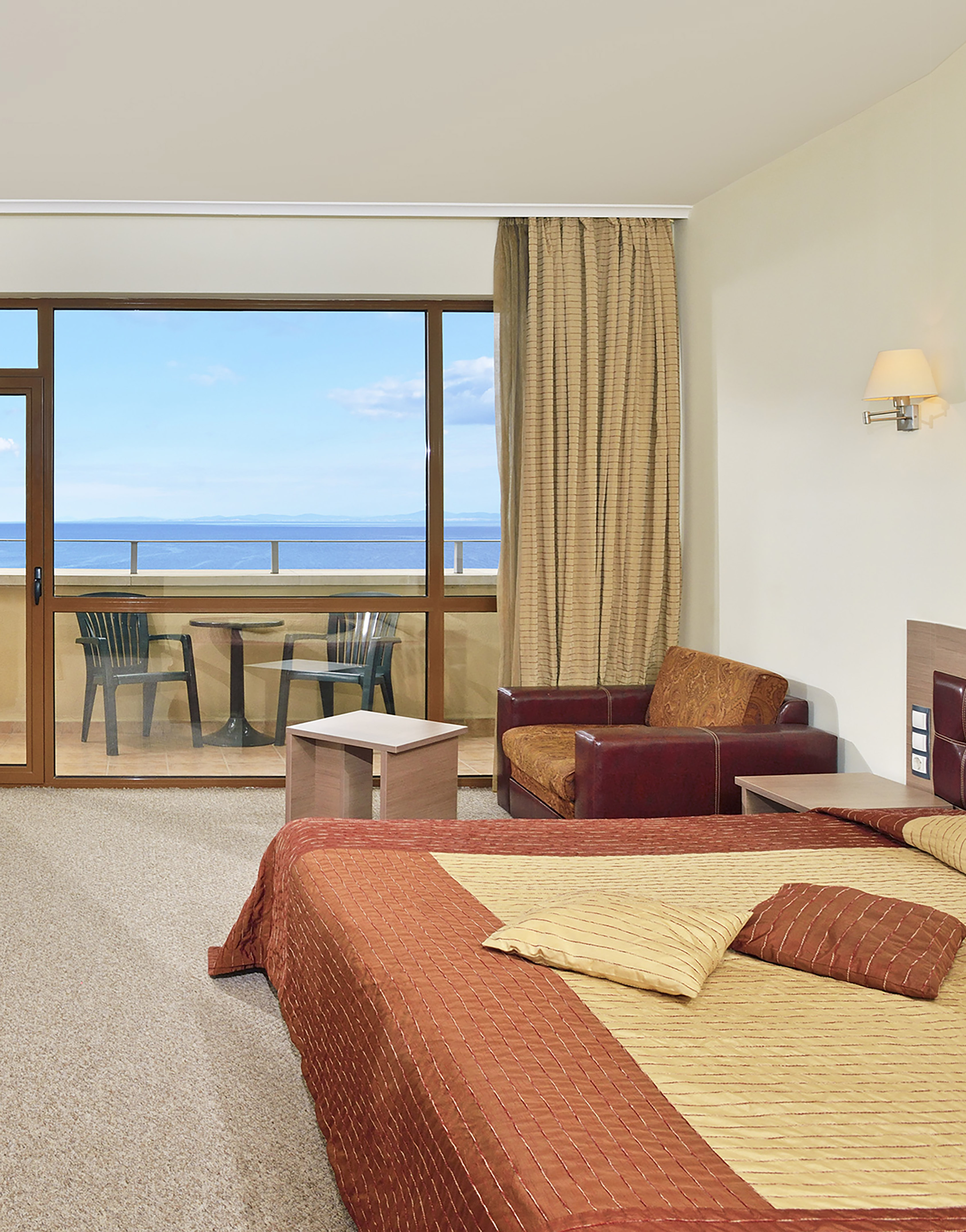 a room with a bed and a glass door