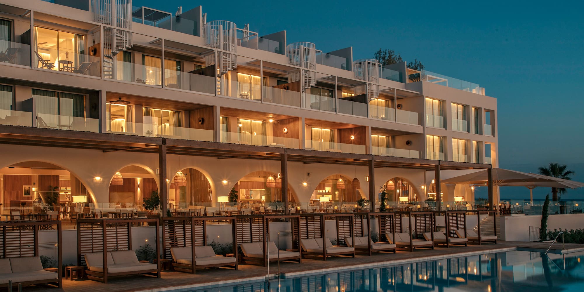 a building with a pool and chairs