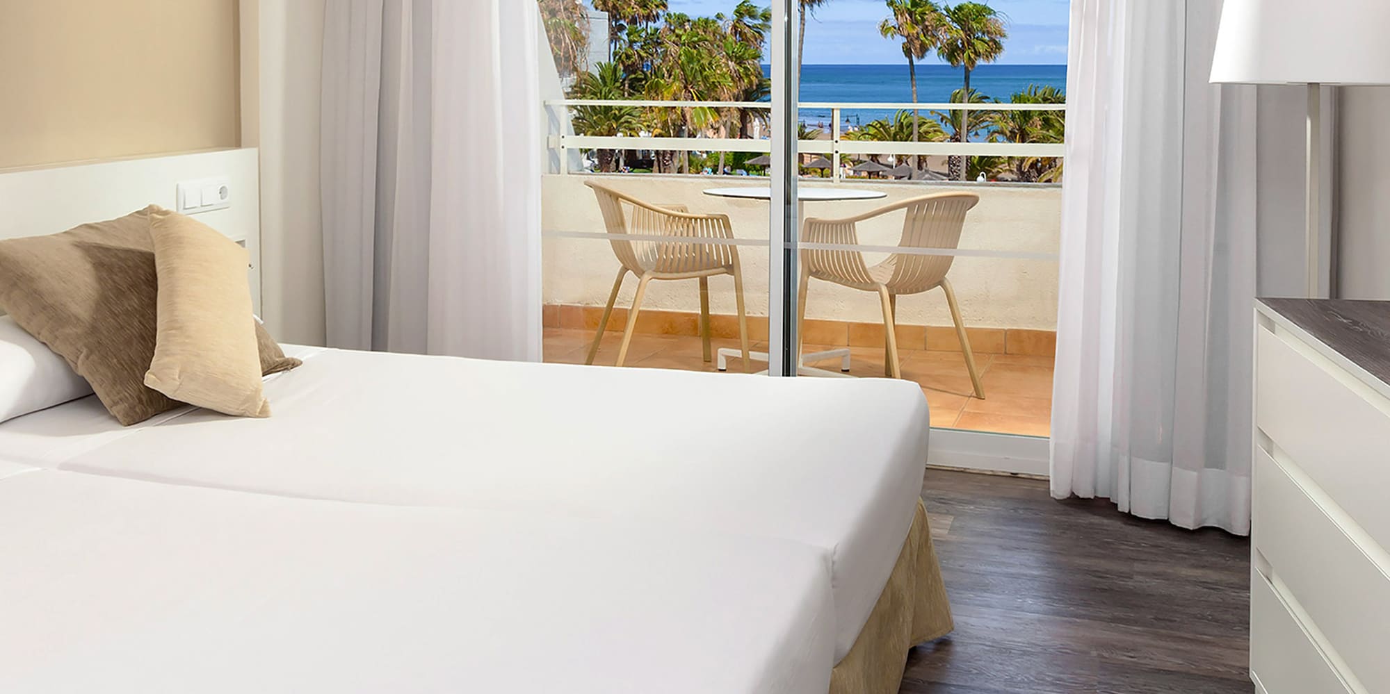 a room with two beds and a glass door