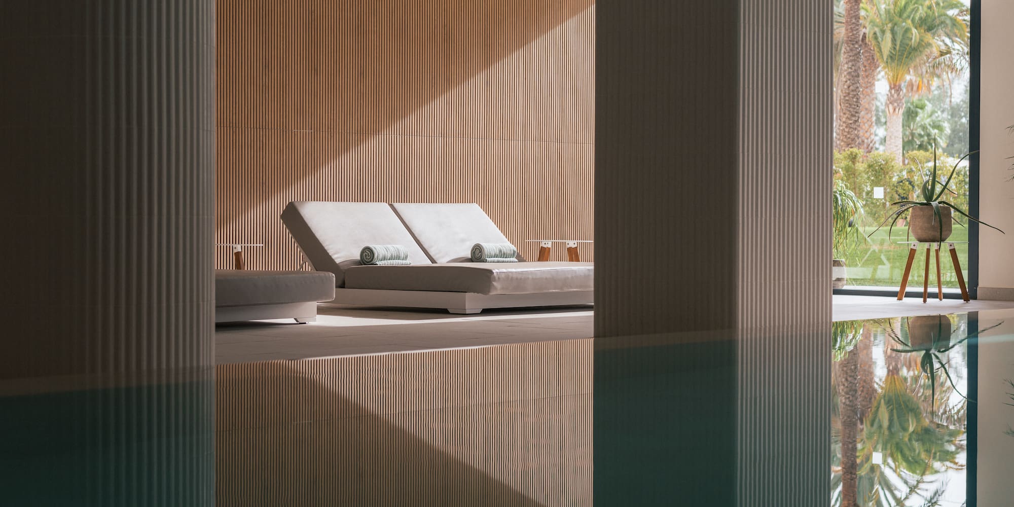 a pool with lounge chairs and a deck chair