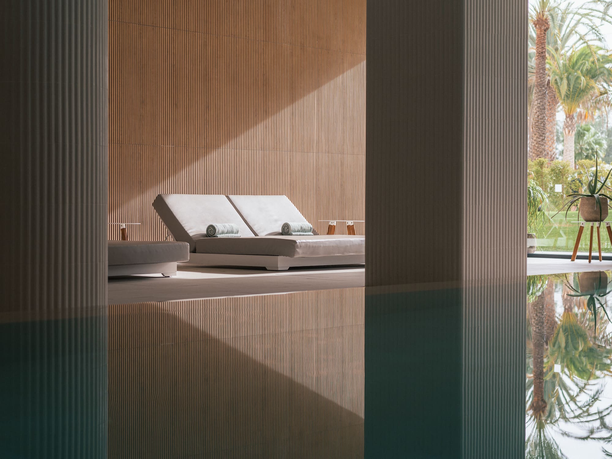 a pool with lounge chairs and a deck chair