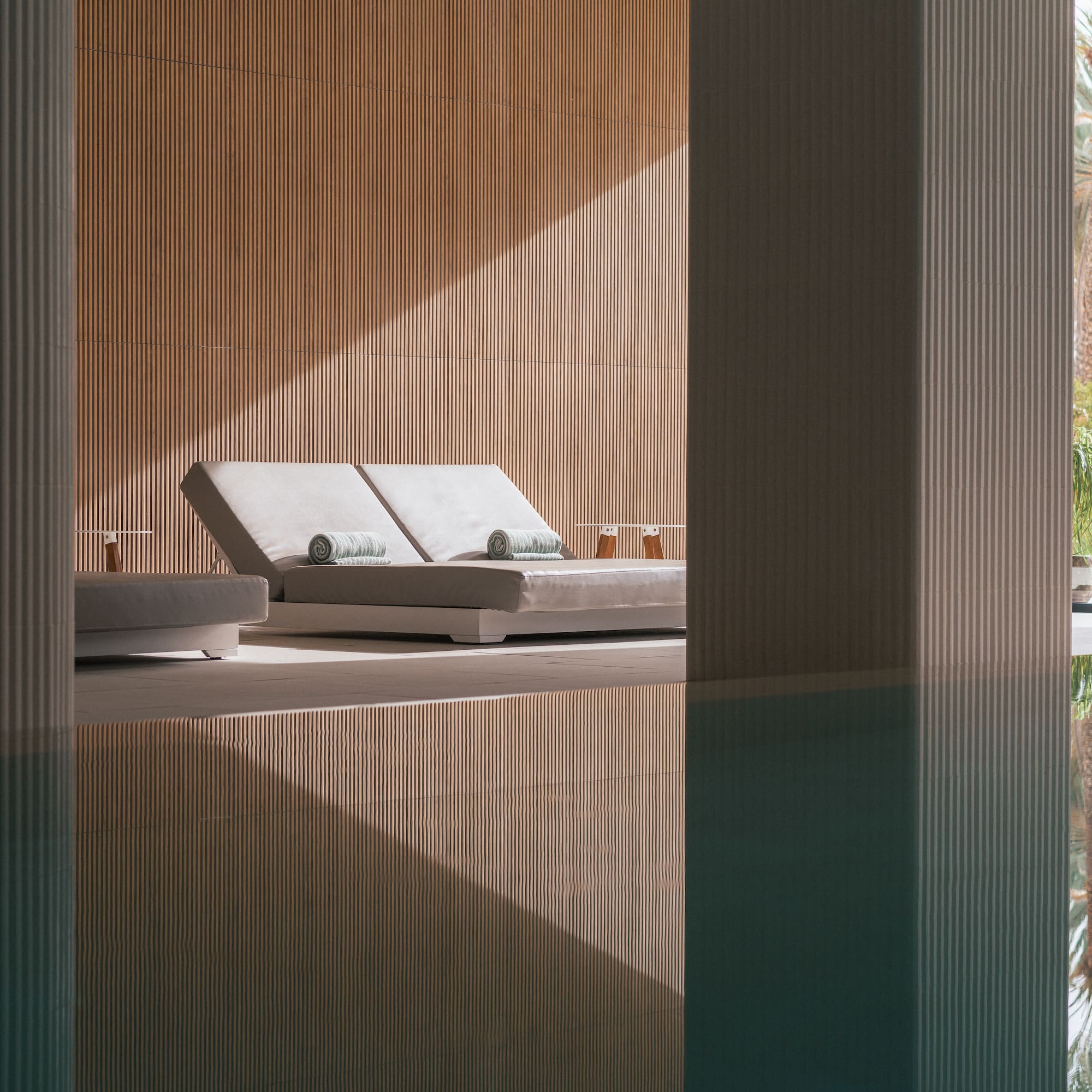 a pool with lounge chairs and a deck chair