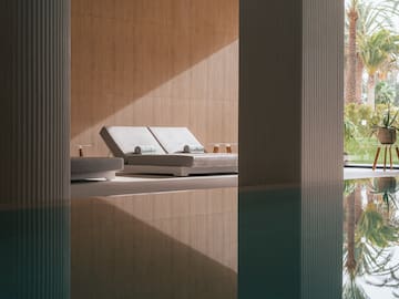 a pool with lounge chairs and a deck chair