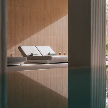 a pool with lounge chairs and a deck chair