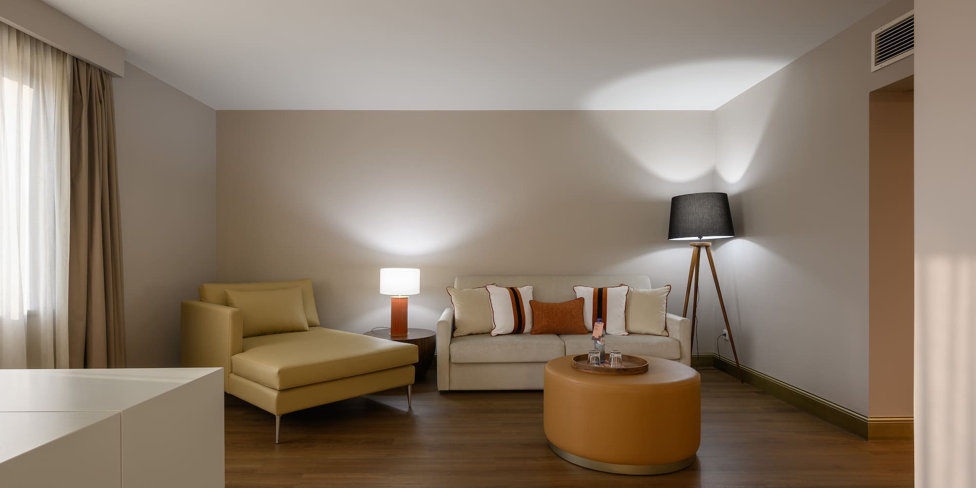 a room with a couch and a lamp