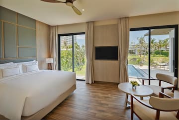 a room with a bed and a television