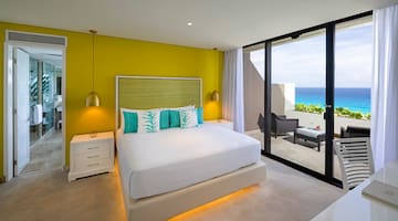 a bedroom with a large bed and a glass door