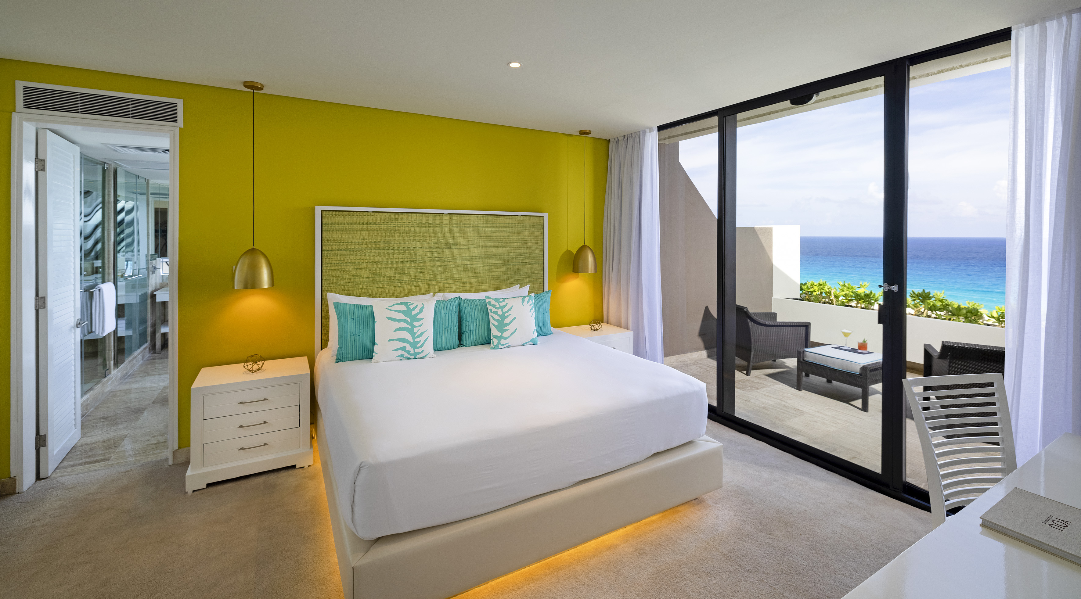 a bedroom with a large bed and a glass door