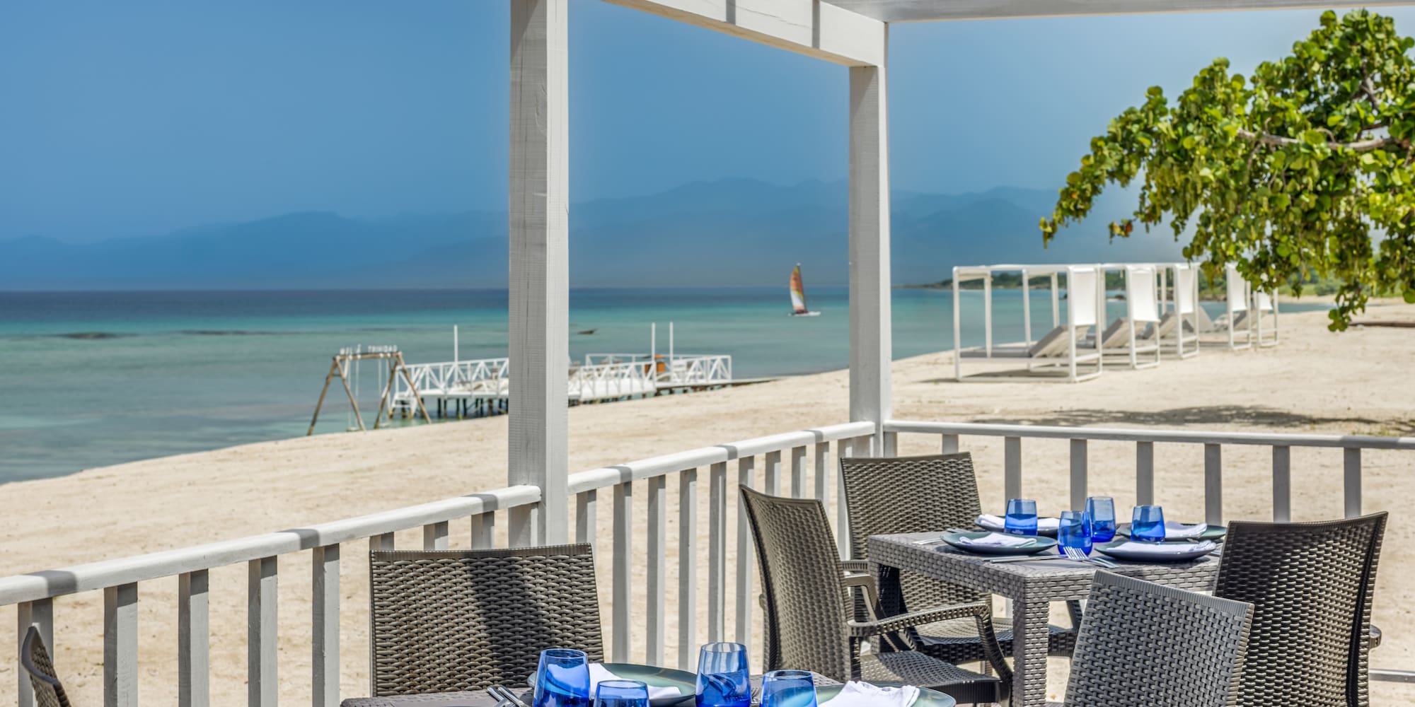 a table set up on a deck overlooking a beach