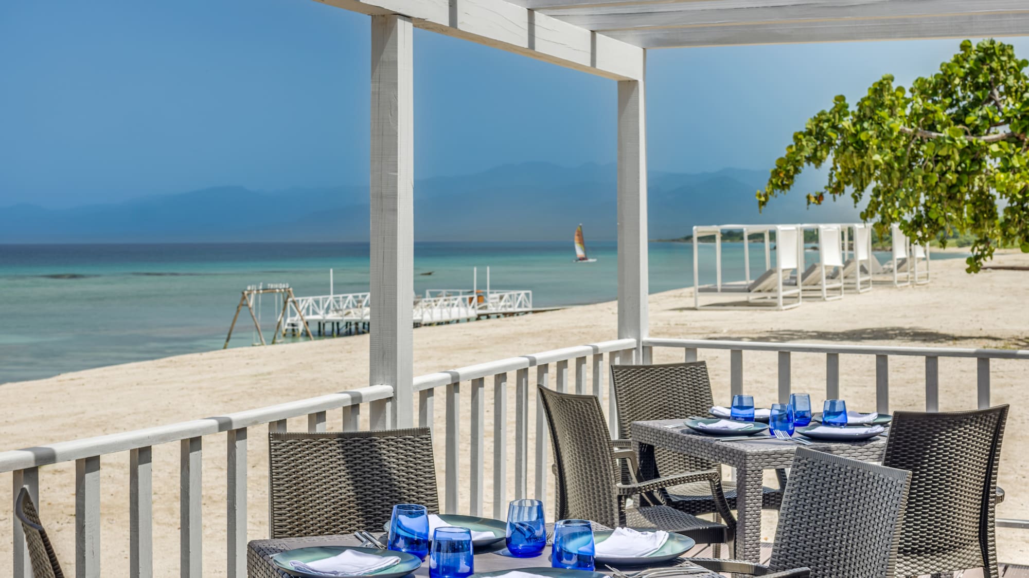 a table set up on a deck overlooking a beach