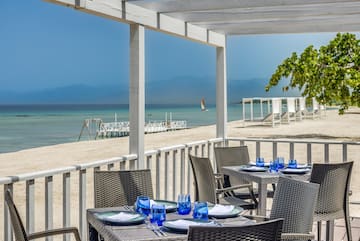 a table set up on a deck overlooking a beach