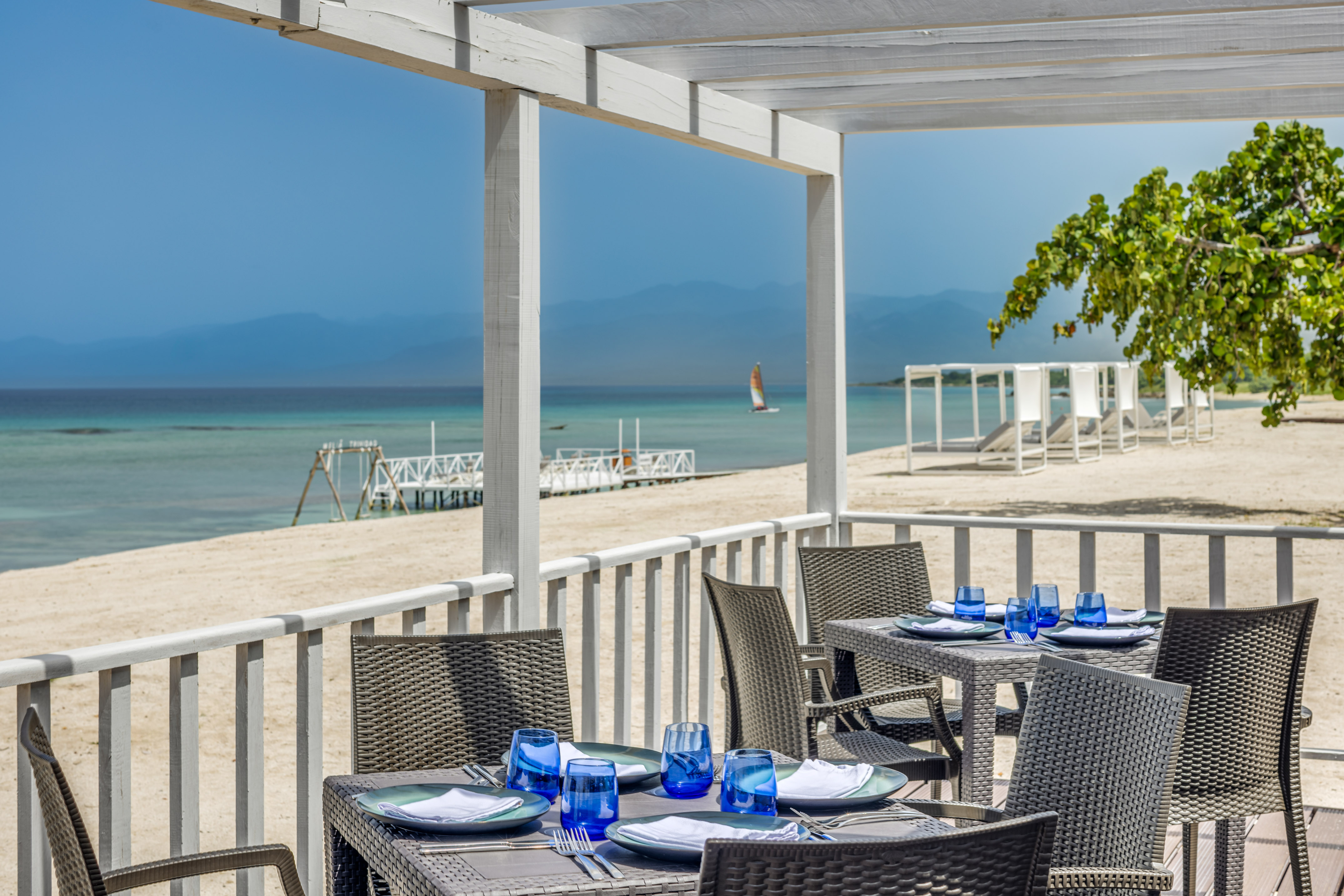 a table set up on a deck overlooking a beach