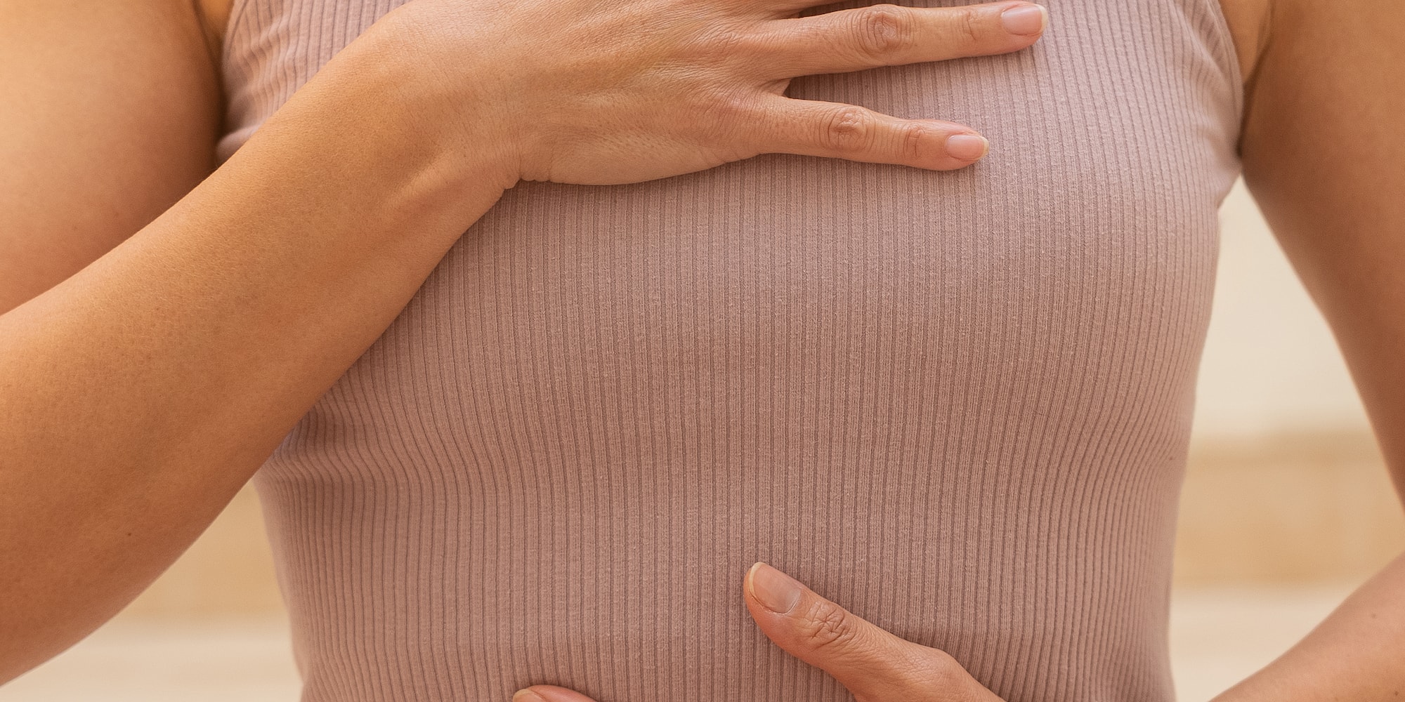 a woman holding her hand on her chest