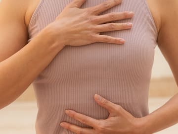 a woman holding her hand on her chest