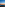 Coastal sunrise with palm trees, ocean, and a vibrant orange sky.
