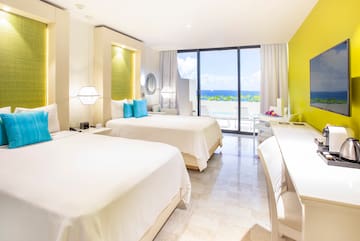 a room with two beds and a glass door